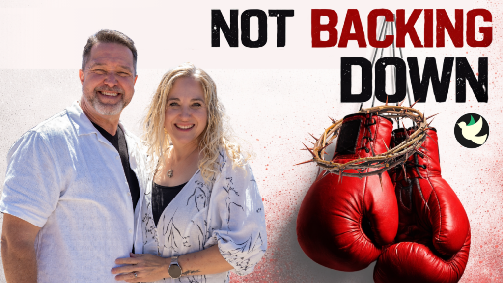 Smiling man and woman stand together on the left; red boxing gloves with a thorn crown on the right and the words NOT BACKING DOWN above.